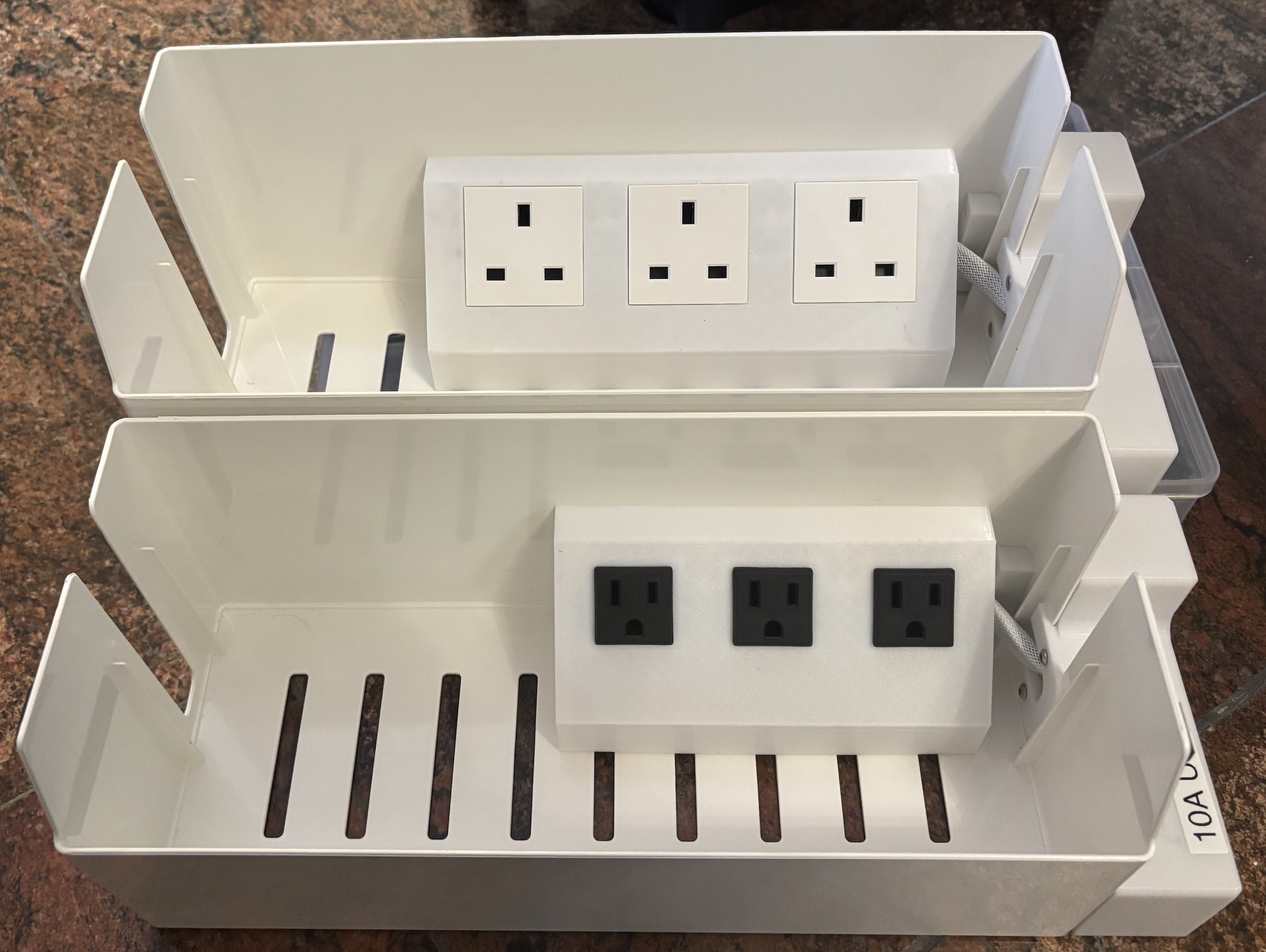 Two of SÄTTING from IKEA converted into extension cords for two types, note that one of them (being NEMA) is not easily buildable as the organizer itself isn't available there.