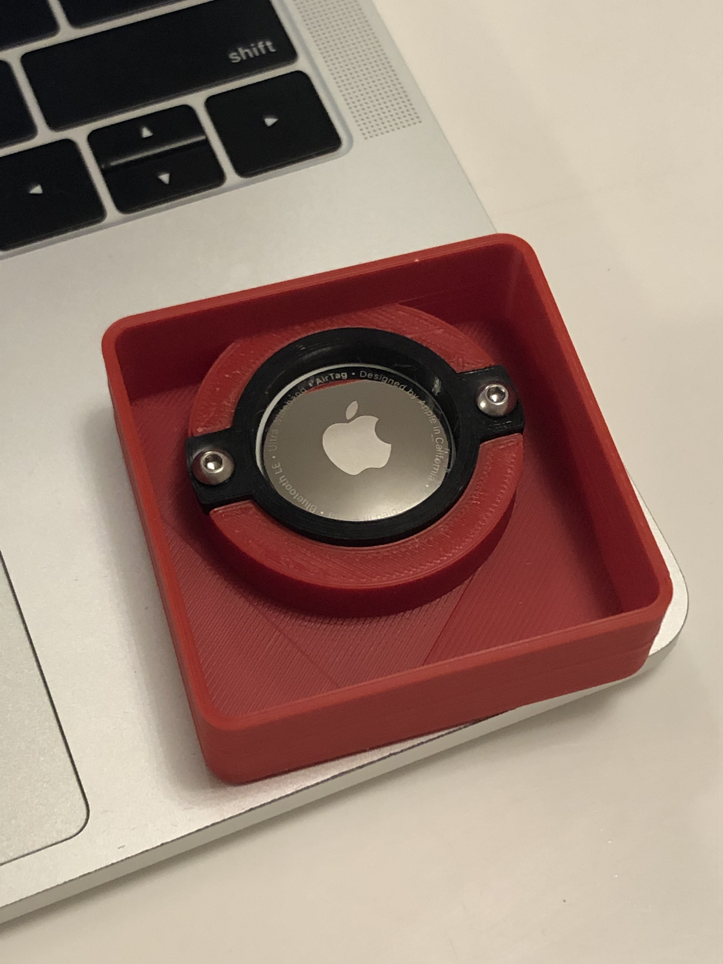 First generation of AirTag tracker with an actual AirTag attached in.